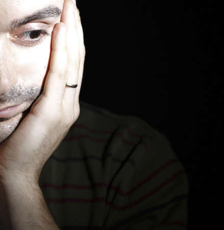 Portrait of a young man, isolated on black backgroundの写真素材