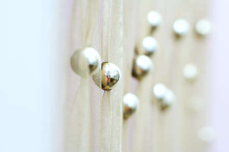 Modern yellow curtain with gold balls.の写真素材