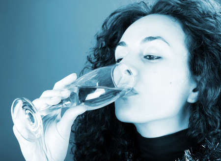 Woman drinking champagne . Happy new year!の写真素材