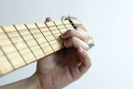 Close up photo of a Young woman playing the guitar