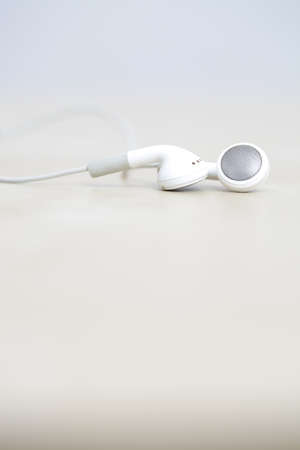 Modern and small earphones on a deskの写真素材