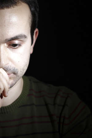 Portrait of a young man, isolated on black background