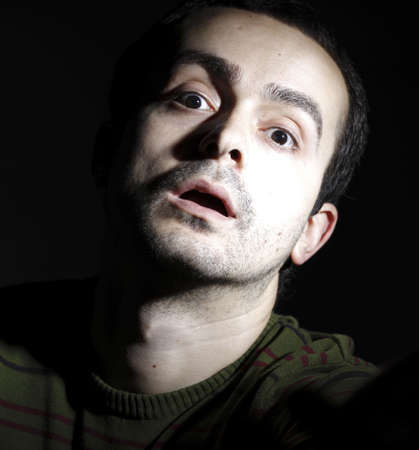 Portrait of a young man, isolated on black background