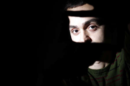 Portrait of a young man, isolated on black backgroundの写真素材