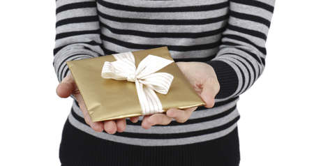 Young woman holding a present in hands