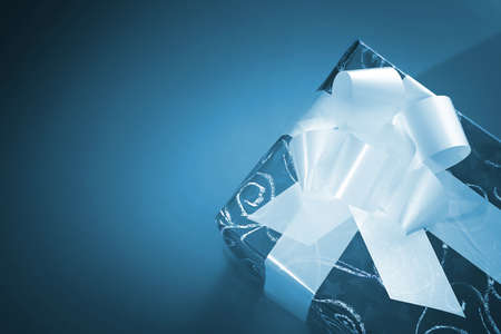 Christmas present box with a white bowの写真素材