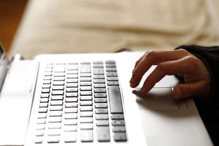 Young woman working on a gray laptop