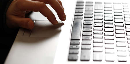 Young woman working on a gray laptop