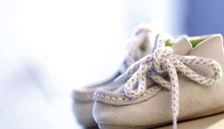 Close up photo of a pail of small slippers for toddlersの写真素材