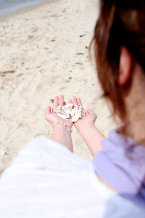 Scallop in a woman hands.の写真素材