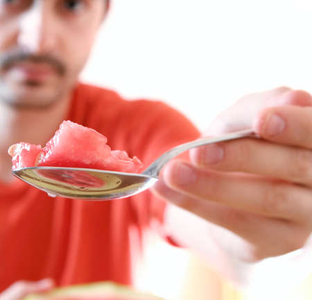 Man eating a slice of watermelon.の写真素材