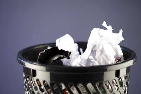 Close up photo of a trash can full of papersの写真素材