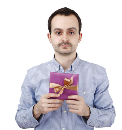 Young man holding a present in hands.