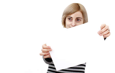Young blonde woman holding a blank piece of paper.