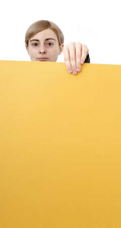 Young blonde woman holding a blank piece of paper.の写真素材
