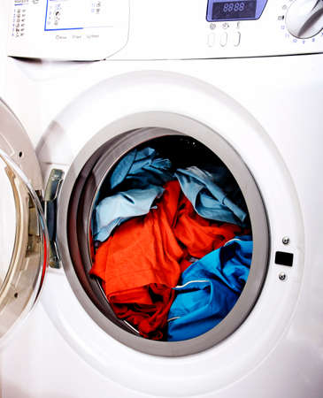 Colorful shirt and trousers in a white laundry.の写真素材