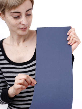 Young blonde woman holding a blank piece of paper.の写真素材