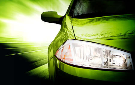 Green Sport Car - Front side - on the road.の写真素材