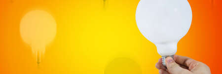 White bulb in a man's handの写真素材