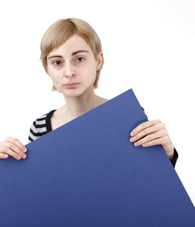 Young blonde woman holding a blank piece of paper.の写真素材