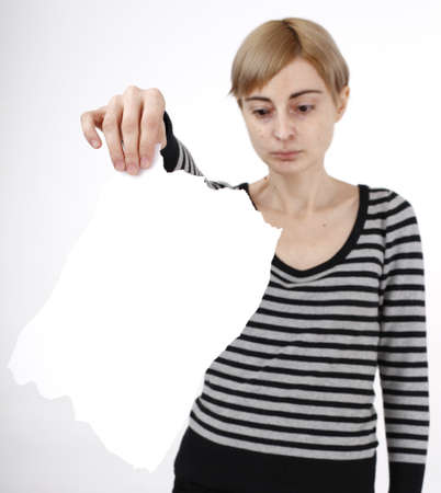 Young blonde woman holding a blank piece of paper.の写真素材