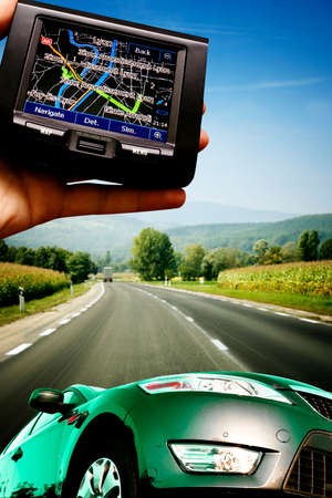 Grate car on the highway. gps in a man hand