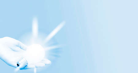 Background with lit lightbulb. Isolated on blueの写真素材