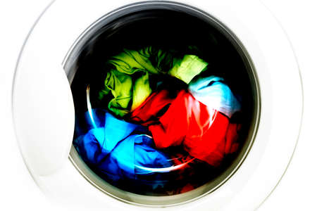 Colorful shirt and trousers in a white laundry.の写真素材