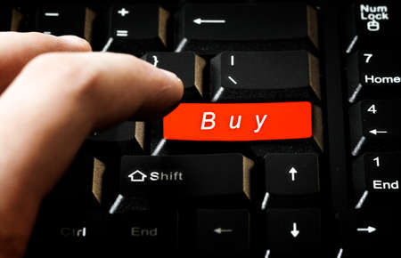 Close-up picture of a computer keyboard - red key buyの写真素材