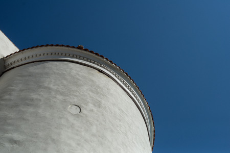 Fragment of white tower agaimst blue skyの写真素材