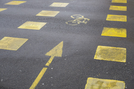 Yellow road markings showing bicycle pathの写真素材