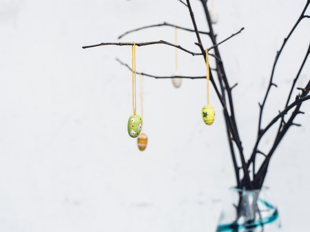 Bare tree branches with colorful Easter eggs decorationの写真素材