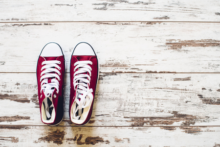 Pair of red trainers on wooden floor top viewの写真素材