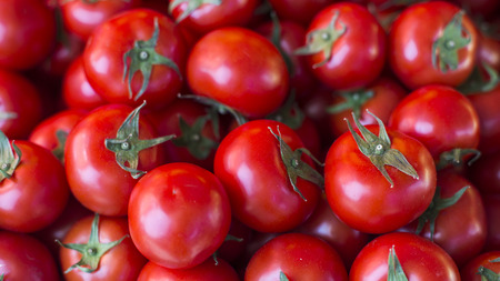Bright red tomatoes on market stallの写真素材