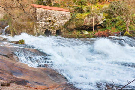 Waterfall, watermill and forest on Barosa river, Barro townの写真素材
