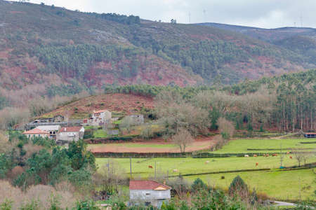 Pastureland and village on rural scene in Cerdedo townの写真素材