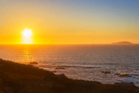 Onceta island on the horizon from Udra Cape at sunsetの写真素材