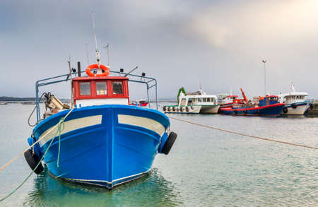 Mussel aquaculture boats moored on Cabodeiro harbor in Arousa Island