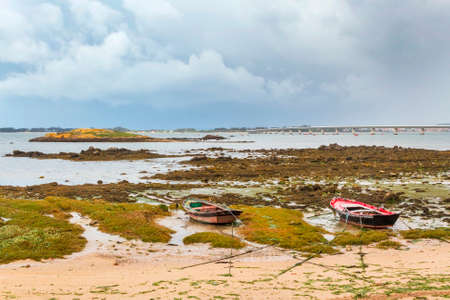 fishing boats, rocky island and bridge to Arousa Island from Patinhas beach in Vilanova de Arousaの写真素材