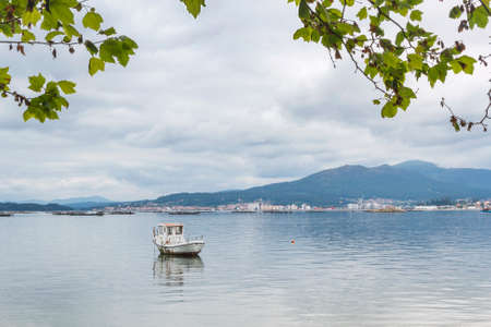 Boat and Xiabre mount in Arousa Estuary from Sinas beach in Vilanova de Arousaの写真素材