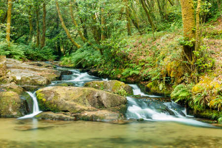 Rocks and waterfall on Armenteira river on the stone and water route in Barrantes, Meis town