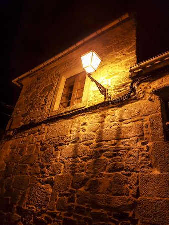 Streetlight and window on a building in Vilagarcia de Arousa at nightの写真素材
