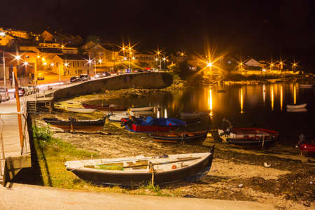 Fishing boats stranded on Naval beach in Arousa Island at nightの写真素材