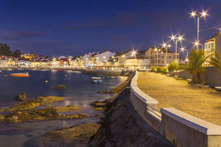 Cantinho seafront and boardwalk in Arousa Island at nightの写真素材