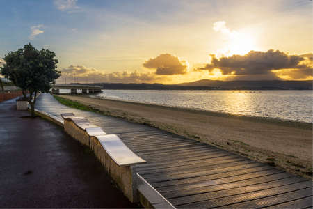 Boardwalk, bridge and Bao beach in Arousa Island at golden sunrise