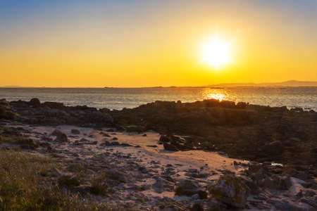 Coastal rock at golden sunset in Arousa Islandの写真素材