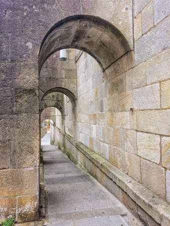 Road under the arches of San Bartolomeu church in Pontevedraの写真素材