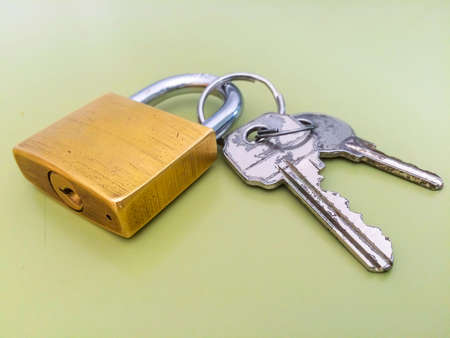 Padlock and keys on green backgroundの写真素材