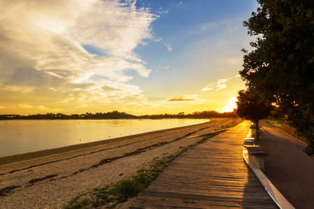 Boardwalk bordering Bao beach at sunset in Arousa Islandの写真素材