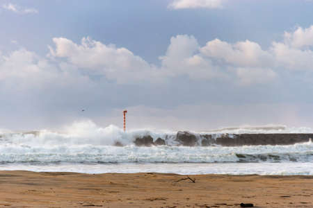 Strong waves on the breakwater of Ancora beach, Portugalの写真素材